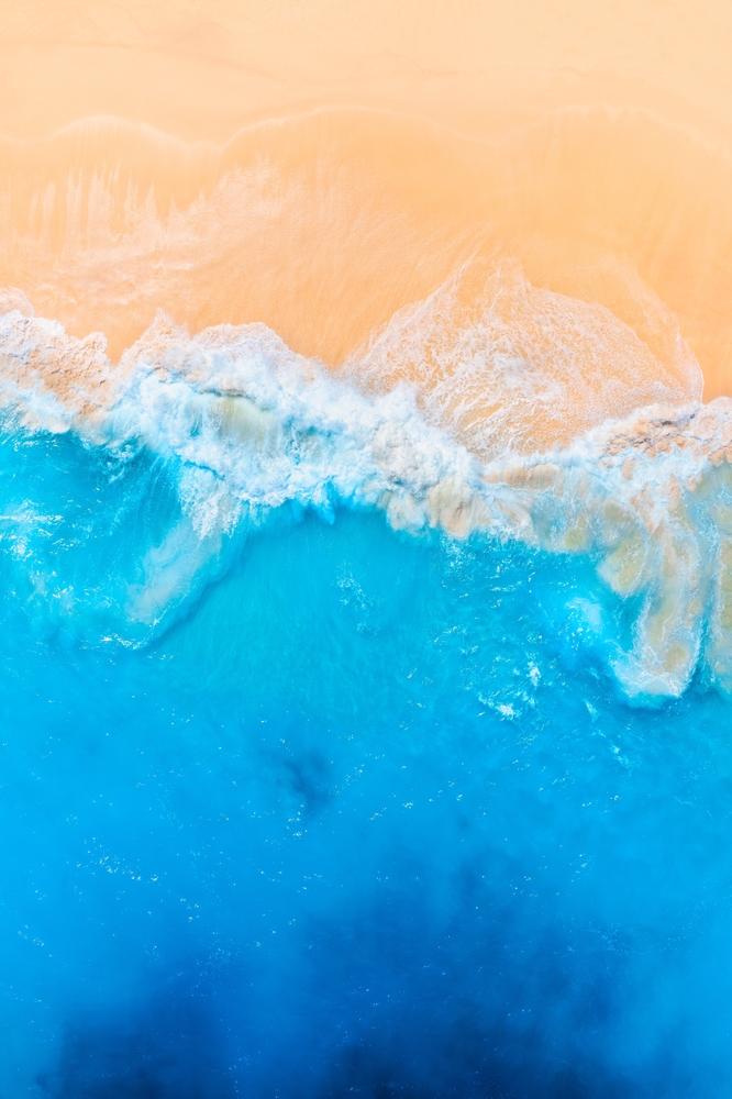 Aerial view of ocean washing up on shore